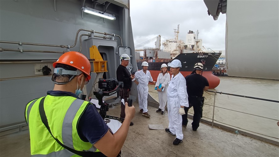 Production team working across an industrial shipyard site in South China