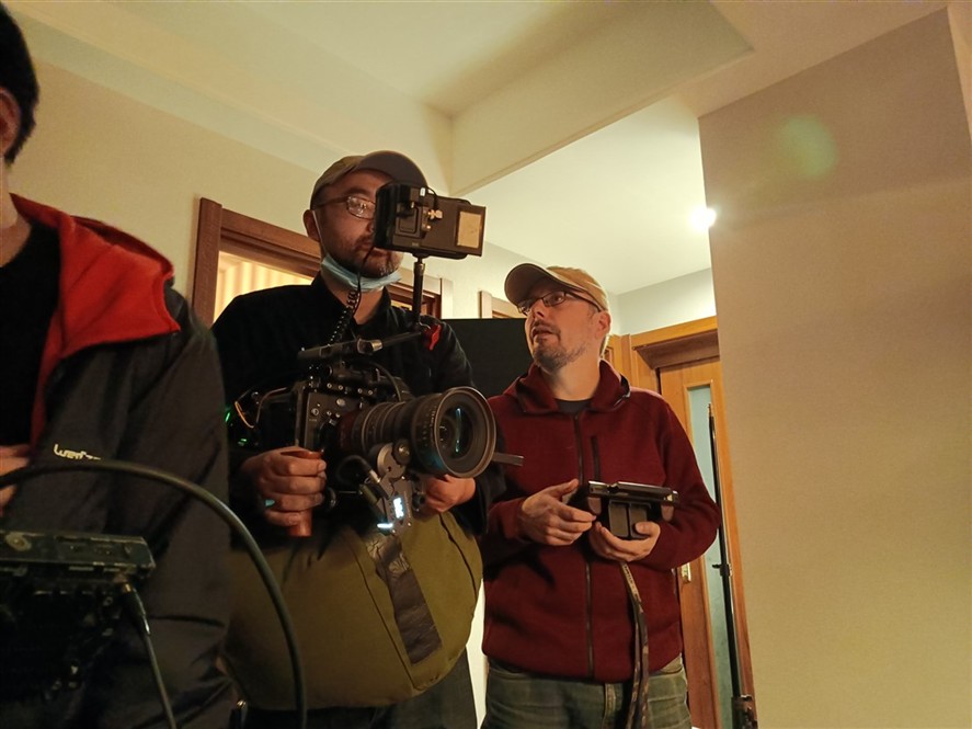 Camera crew reviewing an interior equipment setup in Shenzhen
